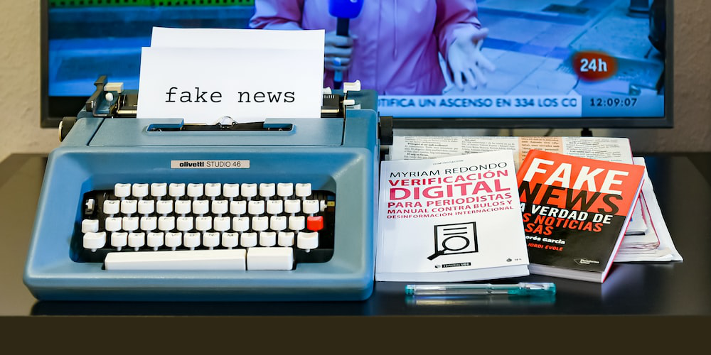 A Typewriter Churning Out a Paper Labeled “Fake News,” Indicating the Defamatory Article About Jody Elliot